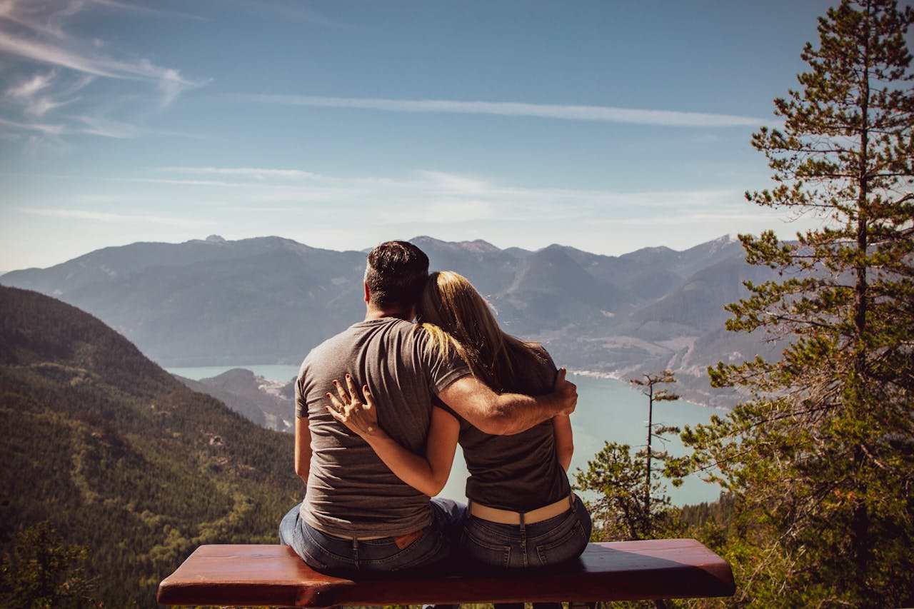 A couple embraces closely, smiling with joy.