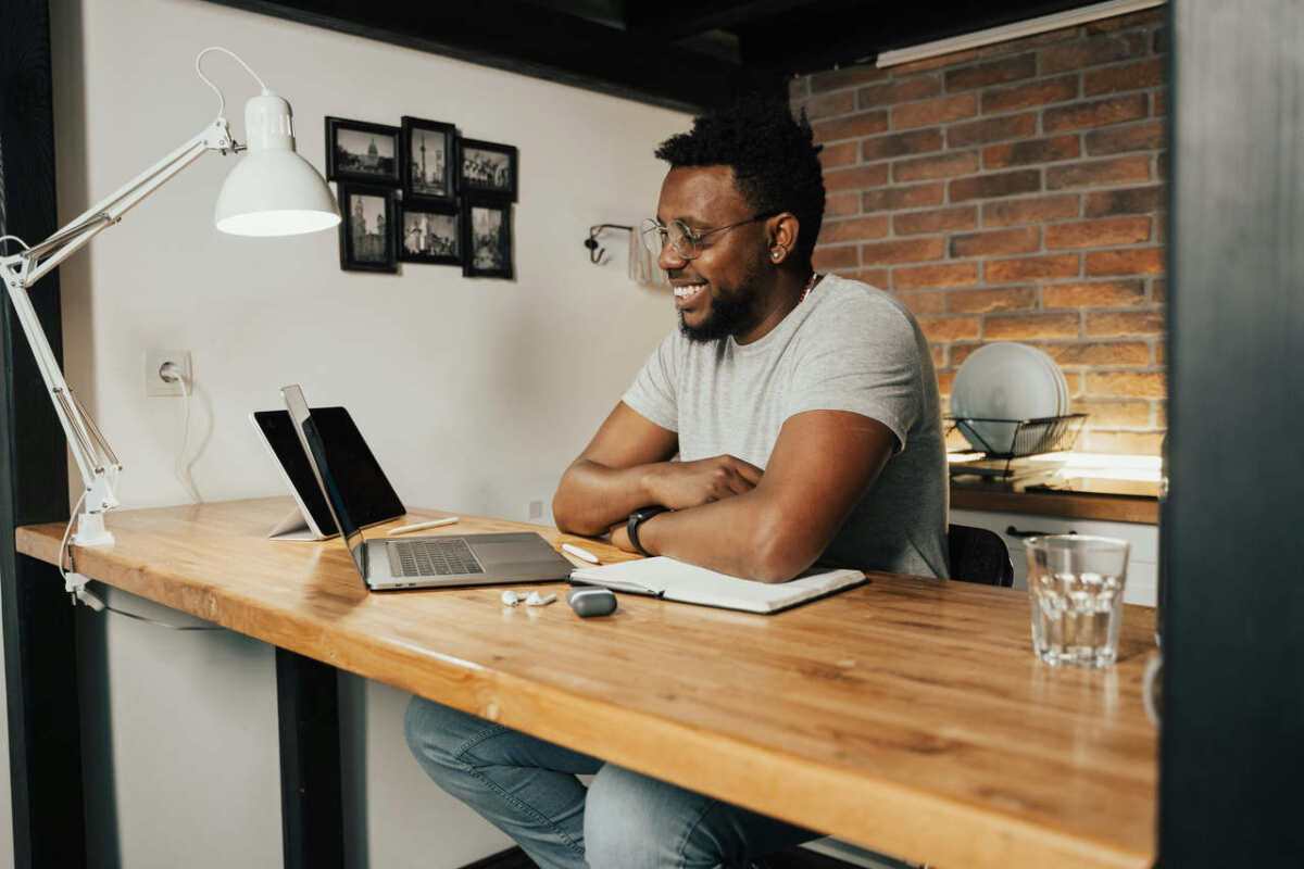 African-American-man-smiling-and-working-remotely-from-home-1.jpg