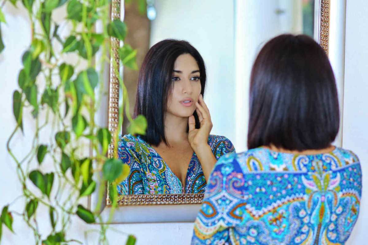 A-woman-standing-in-front-of-a-mirror--reflecting-on-her-tho1.jpg