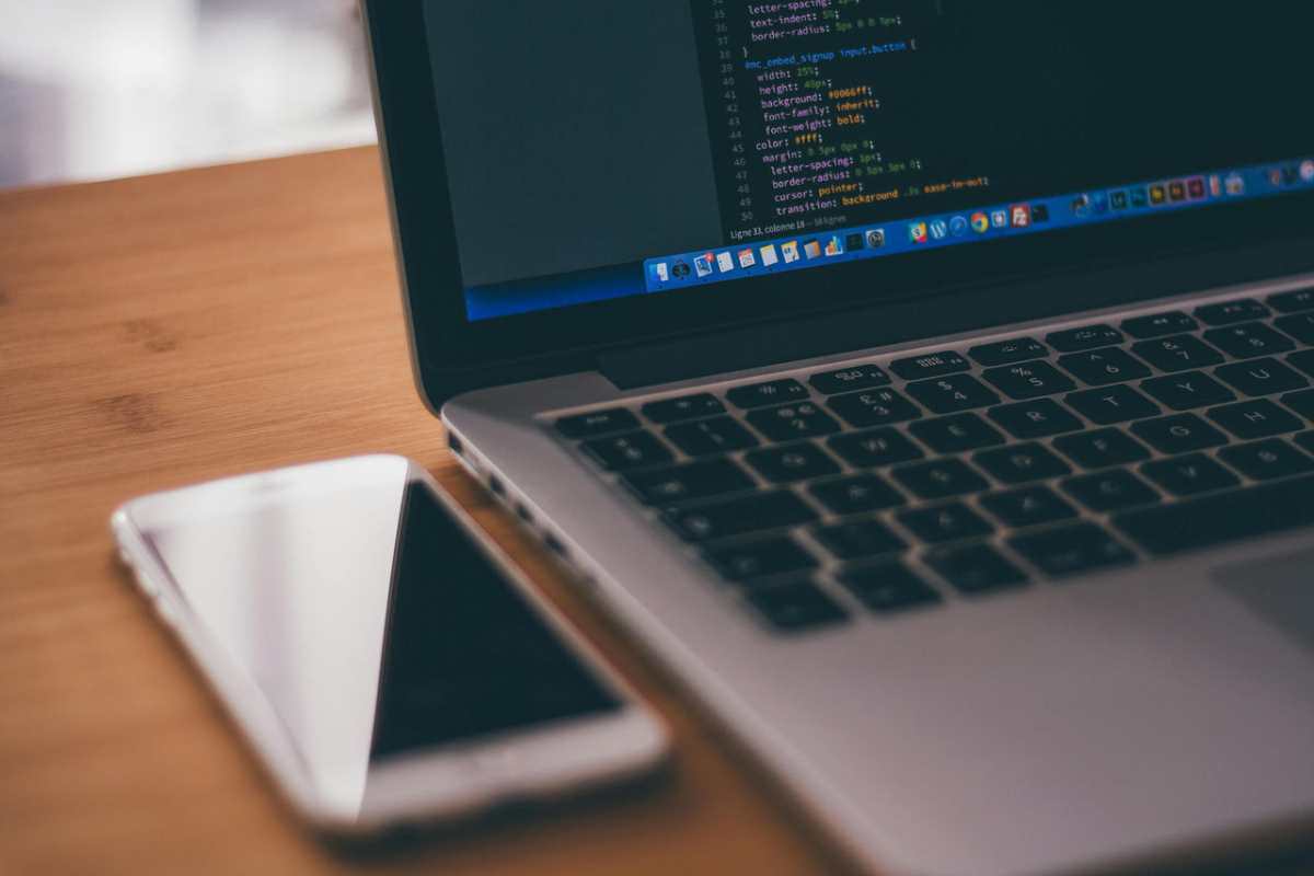 Coding-setup-with-laptop-displaying-code-and-smartphone-on-a1.jpg