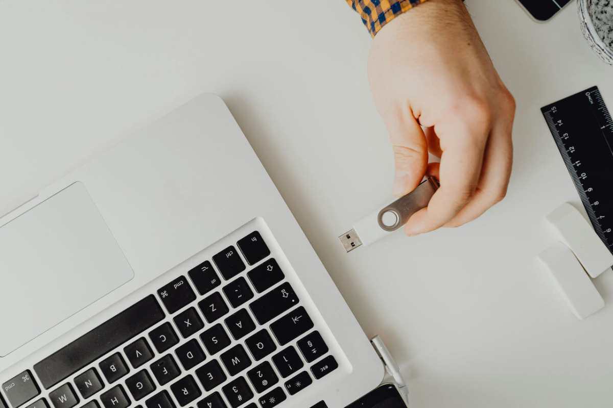 Hand-inserting-USB-drive-into-laptop--Modern-tech-connection1.jpg