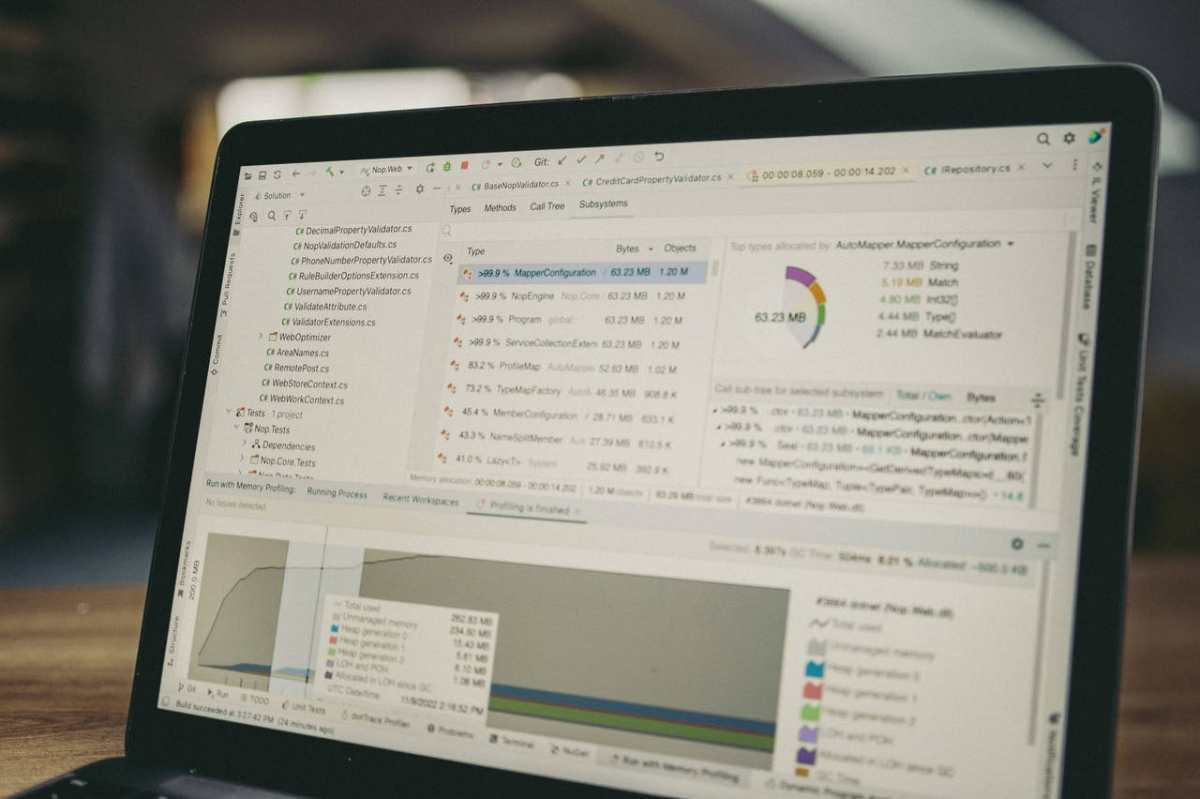 A close-up view of a laptop screen showing a coding and data analysis software interface in an indoor setting.