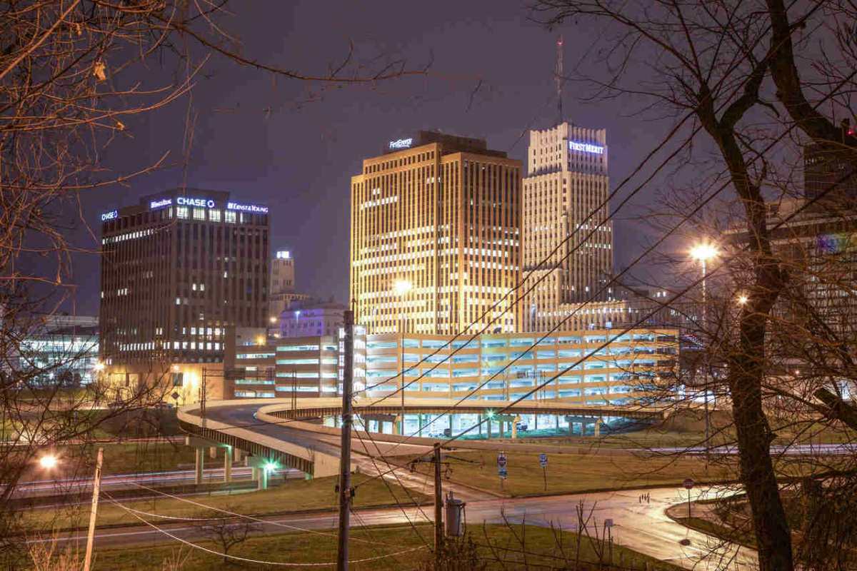 Cityscape featuring illuminated office buildings at night, showcasing modern urban architecture.