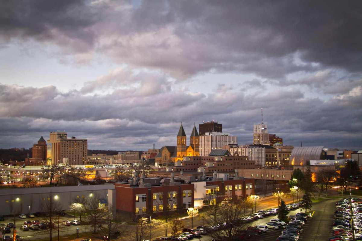 Moody view of downtown Akron, Ohio with an overcast sky during evening.
