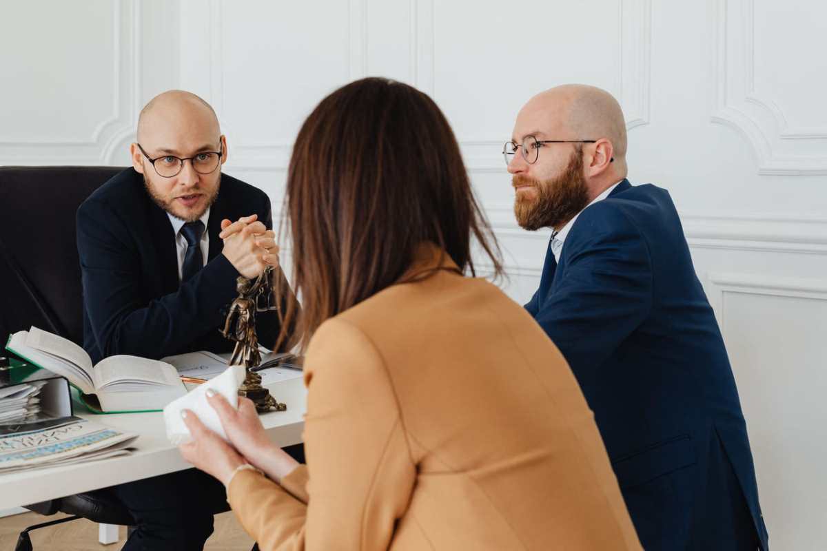 Professional discussion among lawyers in a modern office, focusing on legal matters.