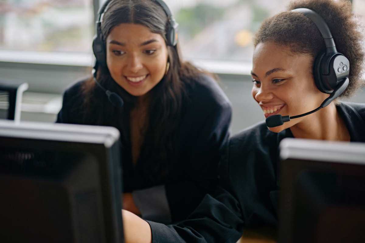 Two cheerful call center agents at work, engaging with customers and providing support.