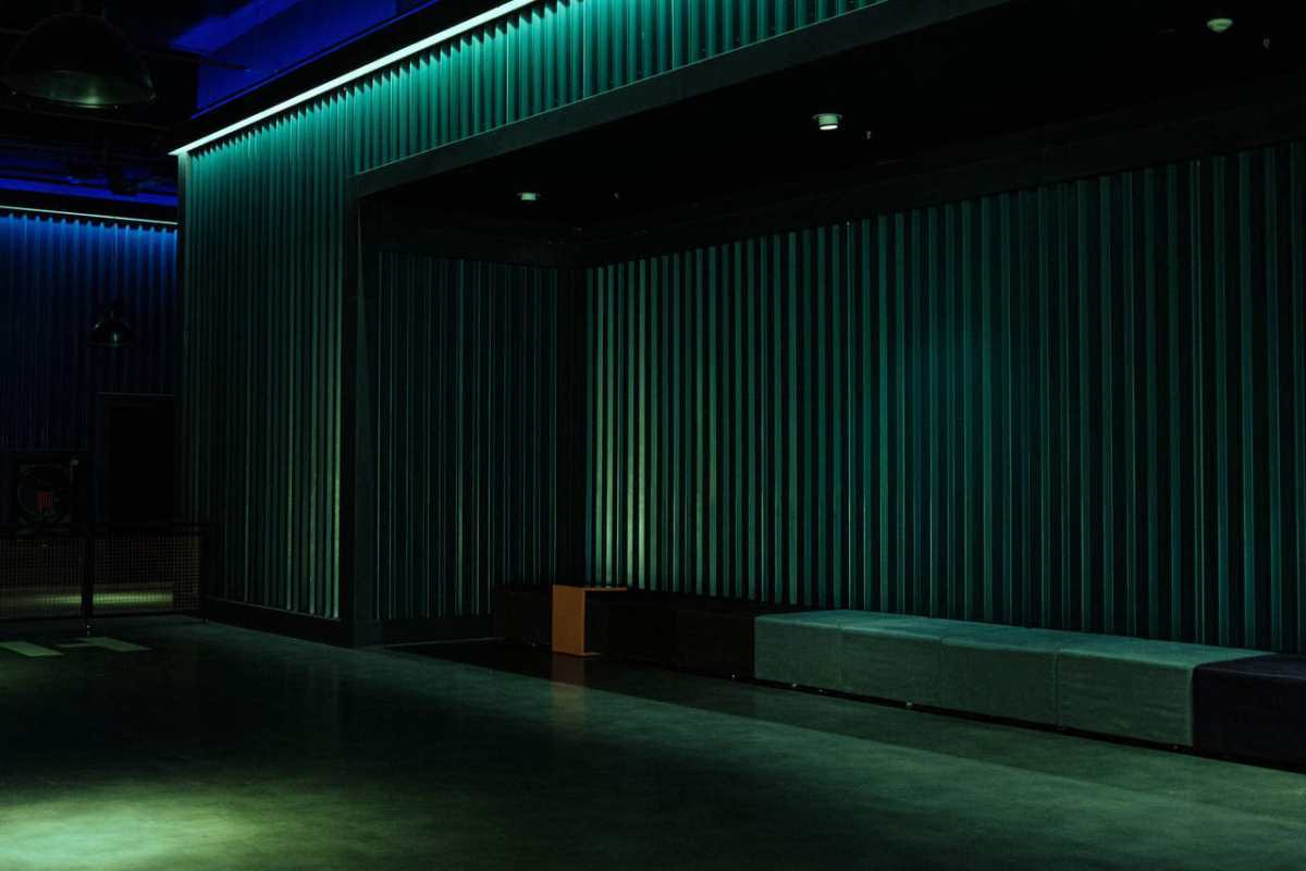 Empty theater space with industrial design and dramatic lighting, ideal for performances.