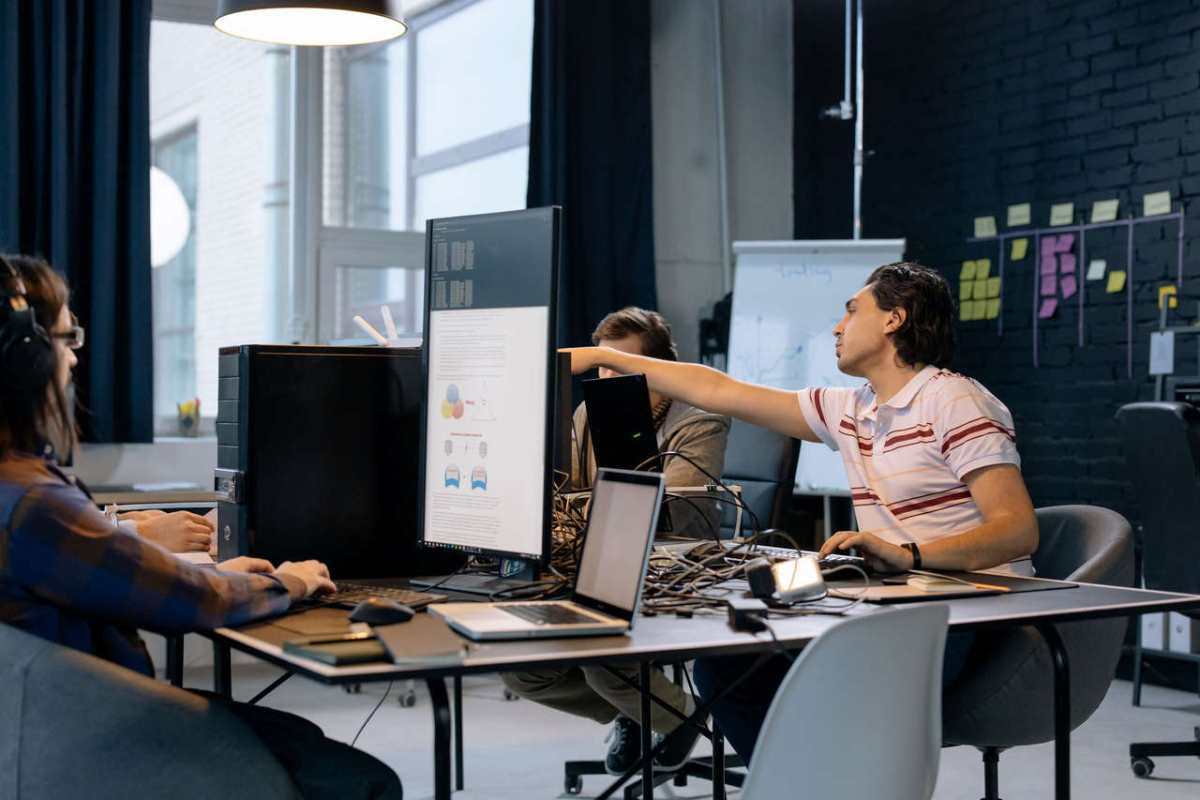 Group of young professionals working on software development in a creative indoor workspace.